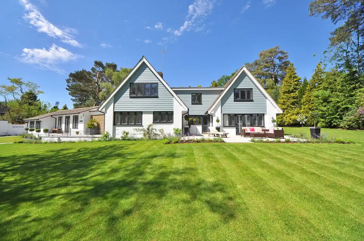 A house with a gray roof and a green lawn